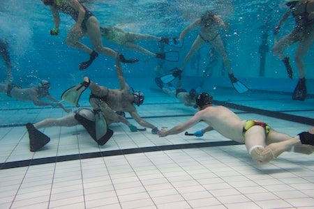 Underwater hockey player fighting for the puck